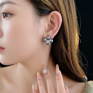 Floral stud earrings featuring grey pearls and crystals on a silver metal rose base