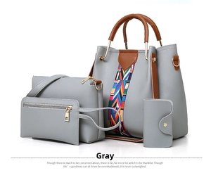 Detail of grey 4-piece handbag set including bucket bag and clutch with woven strap