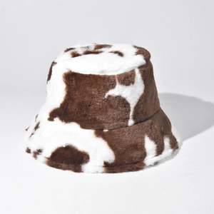 Close-up of soft plush texture on a faux fur bucket hat with brown and white cow print