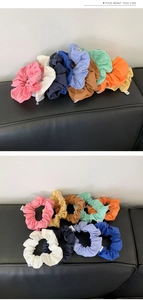 Close-up of colorful cloth hair scrunchies set in various vibrant pastel summer shades