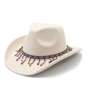 Close-up of beige felt cowboy hat featuring ethnic patterned band and colorful bead tassels