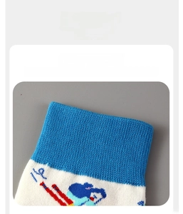 Detail of high-elasticity ribbed blue cuff on cartoon ski themed cotton sports socks