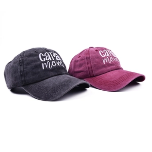 Detail of embroidered cat mom text and paw print on washed cotton baseball caps