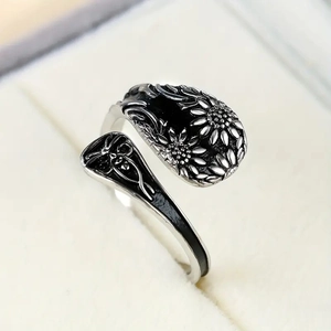 Macro view of vintage bohemian open ring with sunflower and butterfly detailing