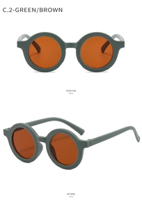 Detail view of round matte green frames and orange-brown lenses for toddler sunglasses