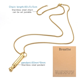 Adjustable golden stainless steel whistle necklace with mindful breathing card on white backdrop