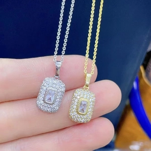 Close-up of gold and silver necklaces with rectangular pave set diamond pendants
