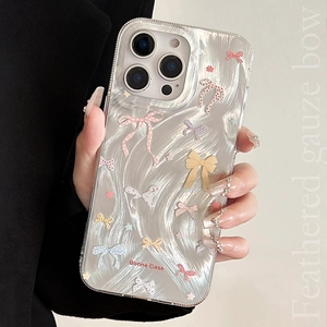 Detail of liquid metal texture iPhone case with colorful 3D bows and stars accents
