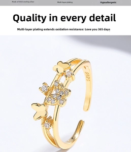Macro shot of 925 sterling silver butterfly ring with sparkling zirconia in gold finish