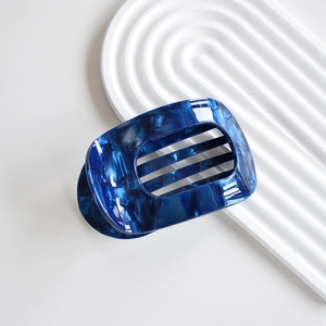 Detail of dark blue marble pattern hair claw clip with elegant acetate texture
