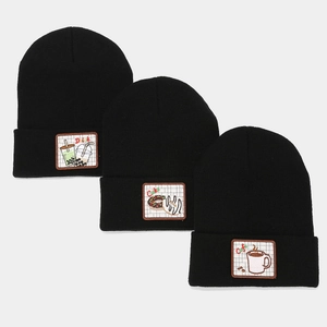 Three black knitted beanies with embroidered dessert patches including cafe and cake icons