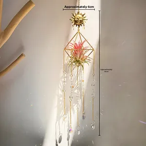 Detail of sun face crystal suncatcher casting rainbow light on a white wall