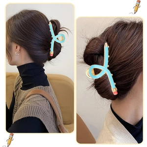 Detail view of a sky blue pencil shaped hair claw clip styled in a sleek ponytail look