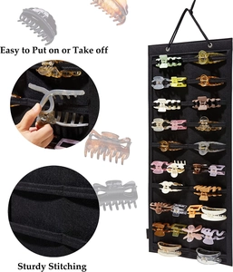 Detail of hanging hair claw clip organizer featuring sturdy stitching and easy access