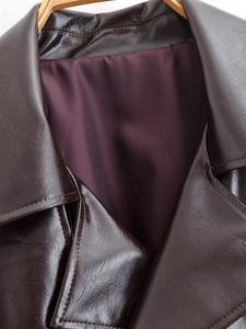 Macro detail of dark brown leather collar and premium deep purple satin lining