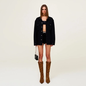 Mid-length washed denim shirt jacket paired with leopard print boots and black accessories