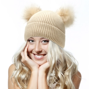 Detailed knit texture and dual faux fur pom-poms on a beige winter beanie for women