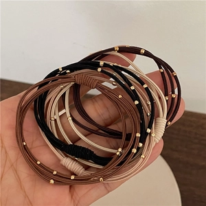 Three-layer elastic hair ties with gold beads in black, brown, and beige colors