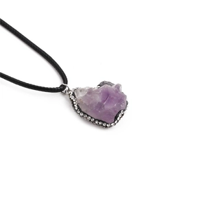 Raw amethyst stone necklace with silver diamond-set frame and black waxed cord