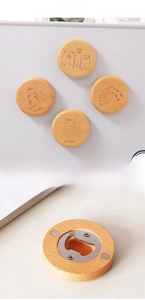 Detail of round beech wood magnetic bottle opener with engraved animal illustrations
