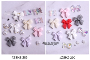 Macro view of crystal resin nail art charms featuring butterfly and bow tie designs