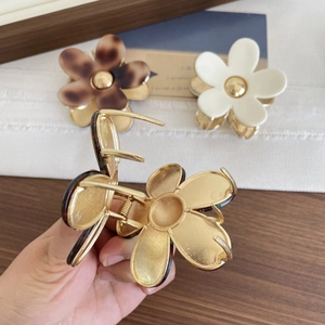Elegant floral hair claw clips in tortoise and cream finishes with metal base