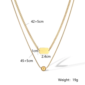 Detailed view of layered gold necklace with MOM engraved pendant and snake chain