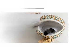 Detailed macro view of floral quilted cotton makeup bag with mesh lining and white zipper