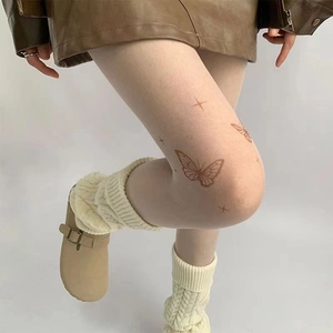 Skin-toned pantyhose featuring delicate butterfly and star tattoo prints for stylish daily wear.