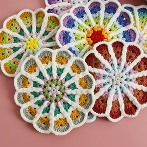 Handmade crochet flower coasters featuring colorful gradient yarn and soft woven textures