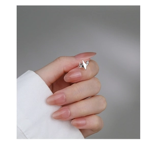 Close-up of S925 sterling silver star ear cuff with sparkling diamonds on a hand