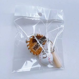 Detail of mini baseball keychain set including glove and bat in transparent poly bag