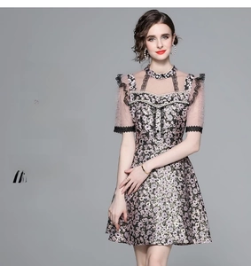 Detail of floral lace patchwork and beaded mandarin collar on slim fit dress