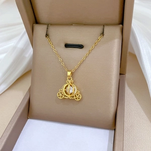 Detail of a luxury pumpkin carriage necklace with crystals in a velvet jewelry box