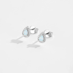 Macro shot of S925 sterling silver teardrop earrings with opal and zircon inlays