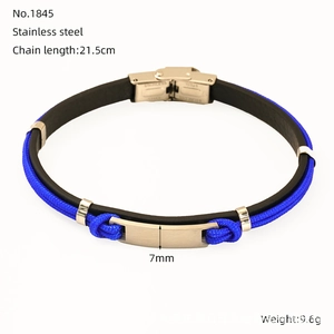 Close-up of blue braided cord and black leather anchor bracelet with steel clasp