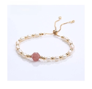 Detail of adjustable pearl bracelet featuring a faceted pink gemstone and gold beads
