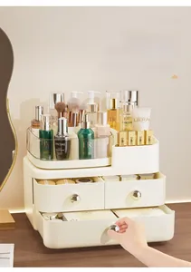 Detail view of cream makeup organizer with dual drawers and gold sphere handles