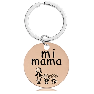 Close-up of rose gold keychain with mi mama engraving and cartoon figures on white base