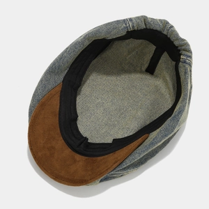 Inside view of vintage washed denim newsboy cap with contrast brown suede brim details