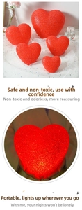 Detail of red heart-shaped LED lights in multiple sizes with a crystalline texture
