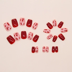 Detail of 24pcs press-on nails with red glossy finish and leopard heart patterns