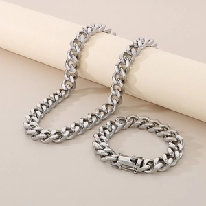 Polished silver cuban chain necklace and bracelet set shown on studio pedestal