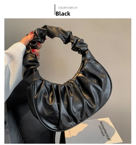Detail of black pleated cloud bag with ruffled handle in matte PU leather finish