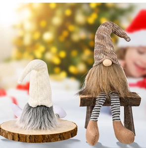 Close-up of plush Christmas gnomes with knitted hats and faux fur beards in festive setting