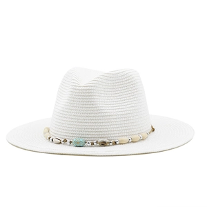 Detail of white straw fedora with bohemian shell and turquoise bead decoration