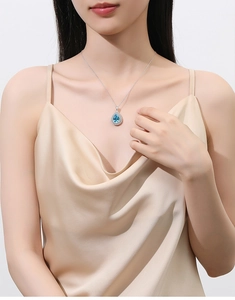 Model wearing a pear-shaped blue carbon diamond pendant with S925 silver chain