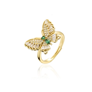 Detail of 18K gold butterfly ring with sparkling white cubic zirconia and green gemstones