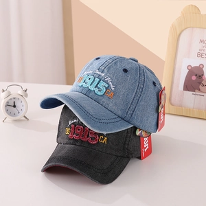 Detailed shot of kids denim baseball caps with vintage 1915 3D letter embroidery