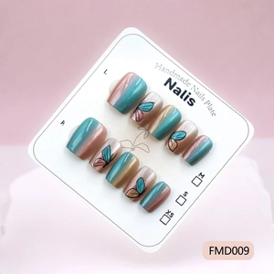 Detailed view of handmade cat-eye gradient press-on nails with butterfly patterns